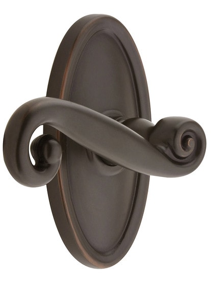Oval Rosette Set With Scroll Design Levers Left Hand in Oil Rubbed Bronze.